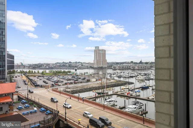 a living room with furniture and floor to ceiling windows