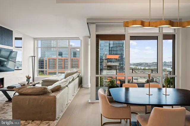 a living room with a couch and a floor to ceiling window