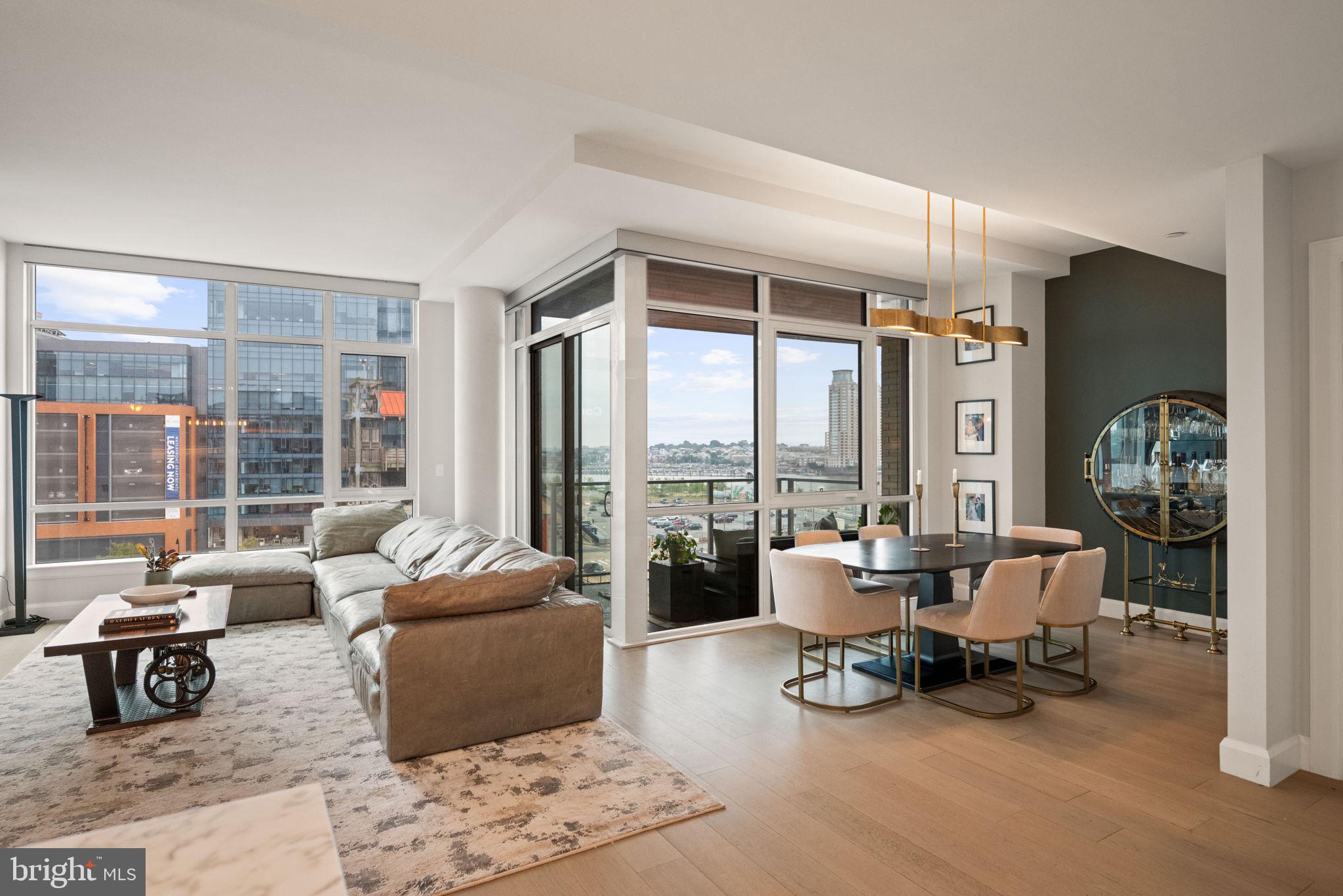 1330 Lancaster Street, Unit C603 Baltimore, MD 21231 - Photo 17 of 63 a living room with furniture and floor to ceiling windows
