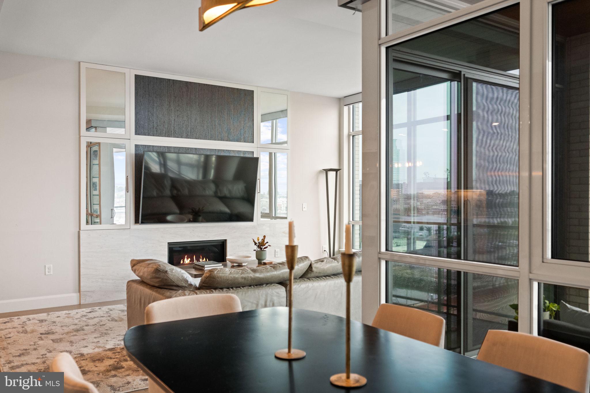 1330 Lancaster Street, Unit C603 Baltimore, MD 21231 - Photo 19 of 63 a living room with a couch and a floor to ceiling window