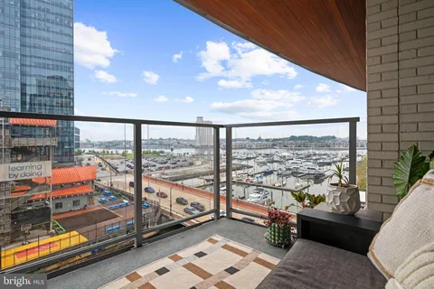 a living room with furniture and large windows