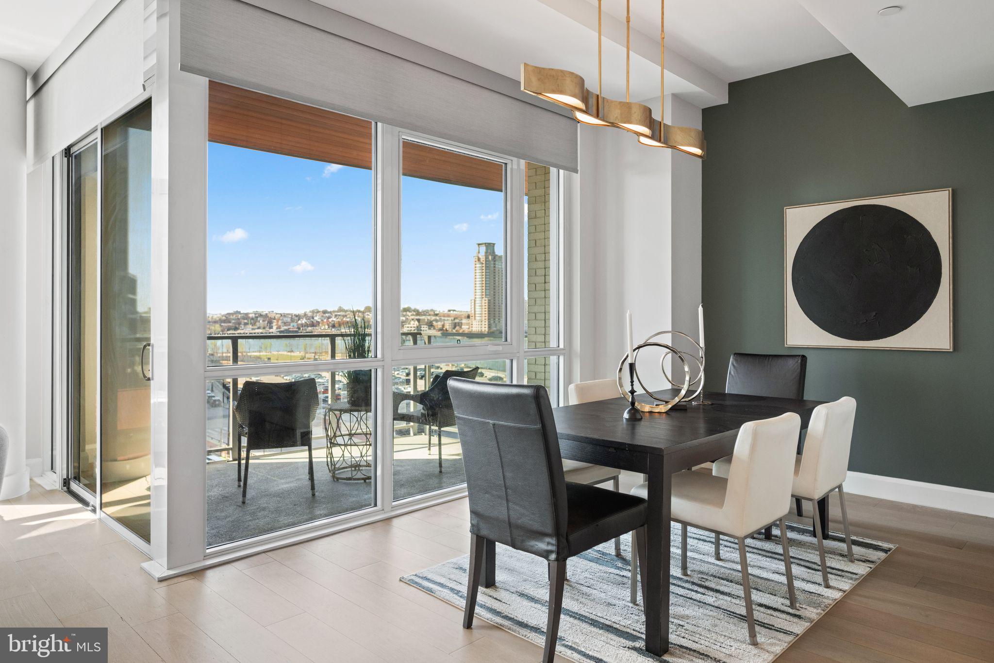 1330 Lancaster Street, Unit C603 Baltimore, MD 21231 - Photo 21 of 59 a dining room with furniture and a floor to ceiling window