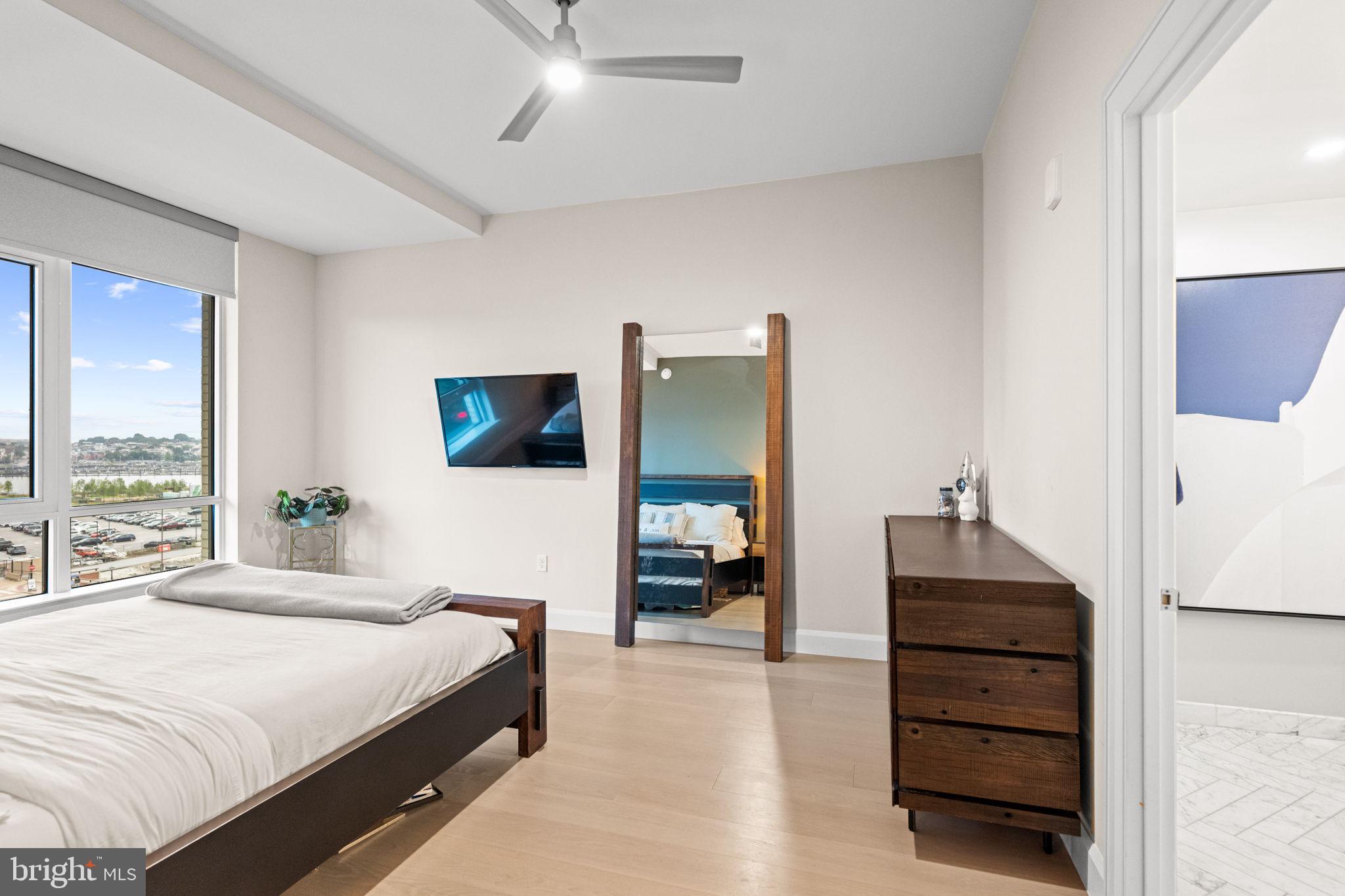 1330 Lancaster Street, Unit C603 Baltimore, MD 21231 - Photo 28 of 63 a bedroom with a bed and a flat tv screen