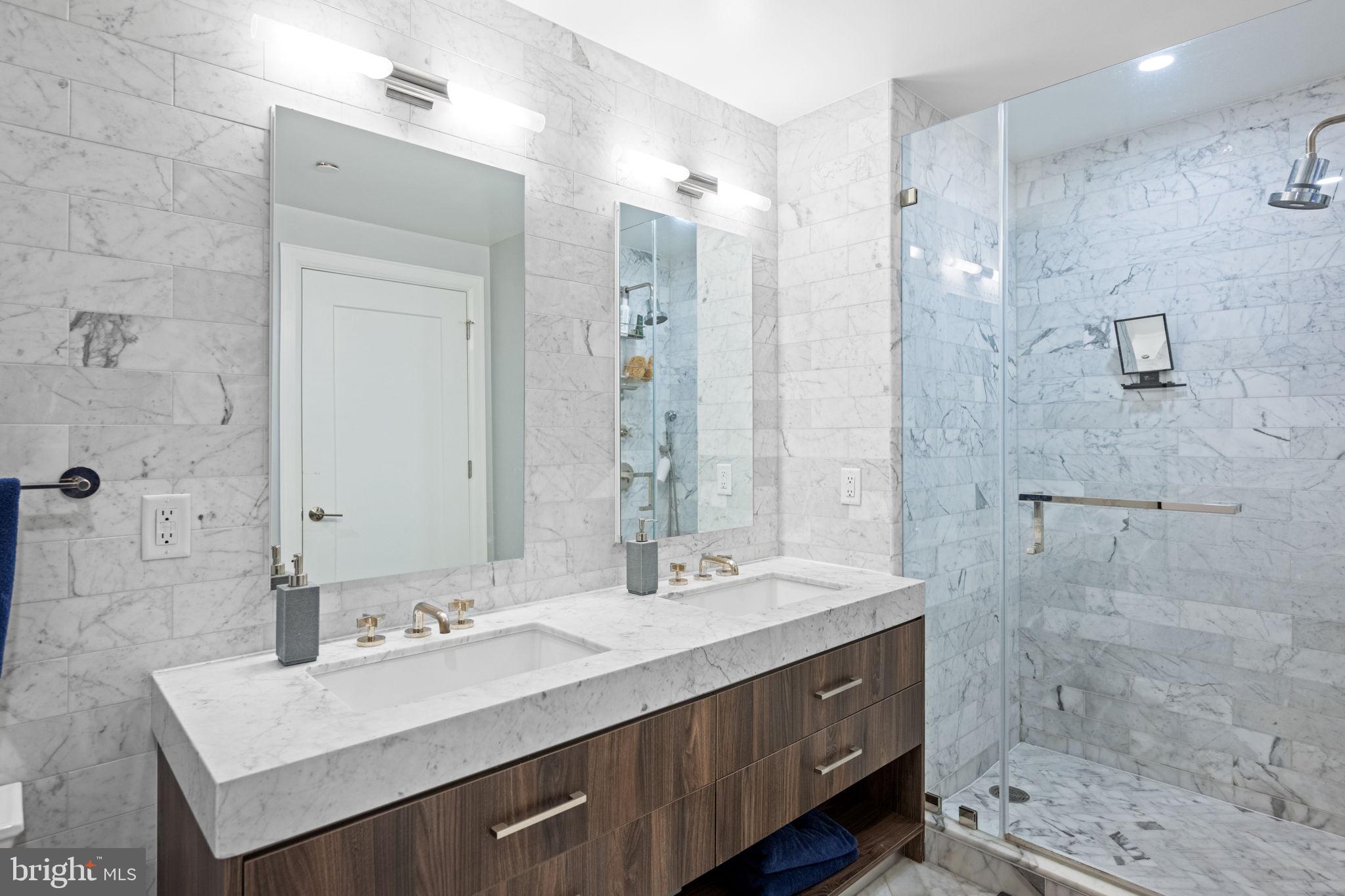 1330 Lancaster Street, Unit C603 Baltimore, MD 21231 - Photo 30 of 63 a bathroom with a double vanity sink mirror and shower