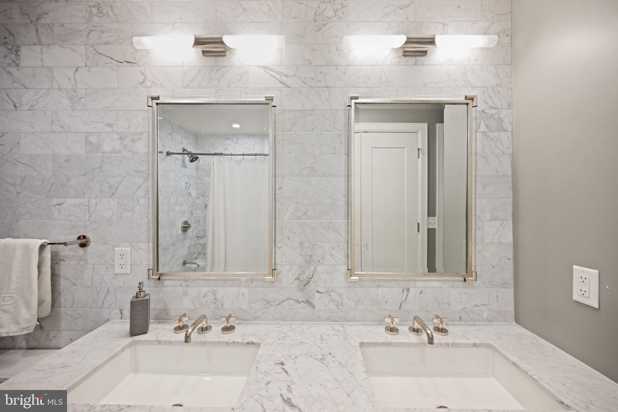 1330 Lancaster Street, Unit C603 Baltimore, MD 21231 - Photo 35 of 63 a bathroom with double vanity sinks and a mirror