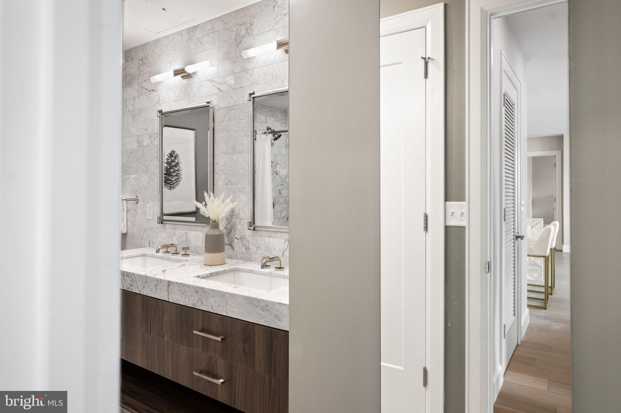 1330 Lancaster Street, Unit C603 Baltimore, MD 21231 - Photo 36 of 59 a bathroom with a double vanity sink mirror and double