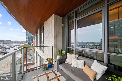 a view of a terrace with lawn chairs