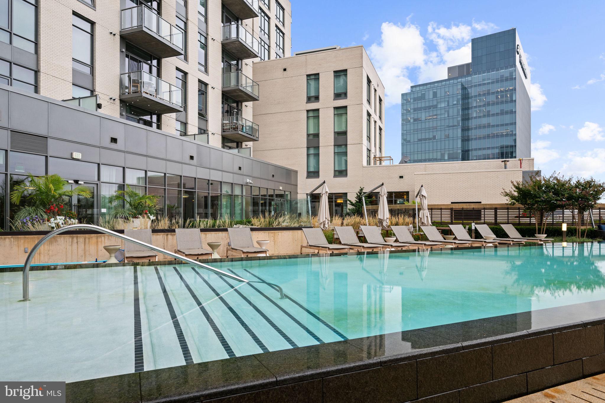 1330 Lancaster Street, Unit C603 Baltimore, MD 21231 - Photo 42 of 63 a view of swimming pool with outdoor seating and city view
