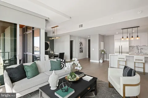 a living room with furniture a fireplace and a dining table
