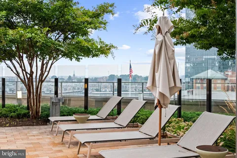 a kitchen with stainless steel appliances granite countertop a stove top oven a sink and a refrigerator