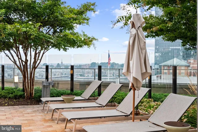 a kitchen with stainless steel appliances granite countertop a stove top oven a sink and a refrigerator