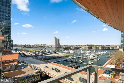 a view of swimming pool with outdoor seating and city view