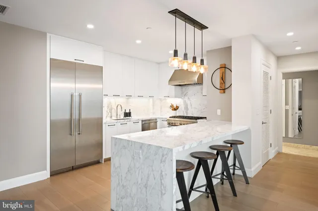 a kitchen with cabinets and steel stainless steel appliances