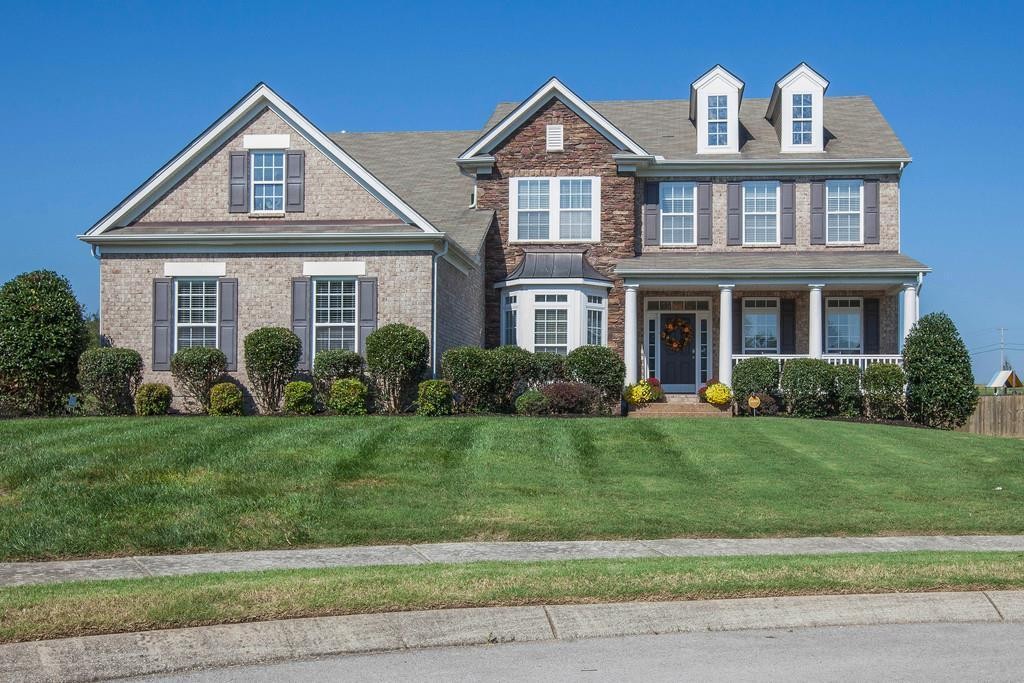 3018 Langston Place Spring Hill, TN 37174 - Photo 1 of 33 a front view of a house with a yard