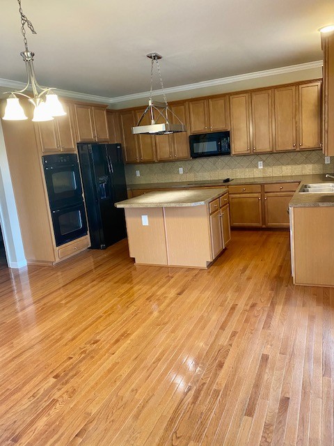 3018 Langston Place Spring Hill, TN 37174 - Photo 10 of 33 a kitchen with stainless steel appliances granite countertop a refrigerator a sink dishwasher a stove with wooden floors