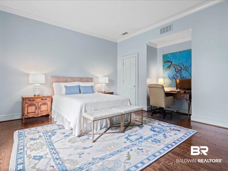 109 Eaton Square Mobile, AL 36608 - Photo 18 of 26 Hardwood flooring and crown molding accent this bedroom with an integrated desk area
