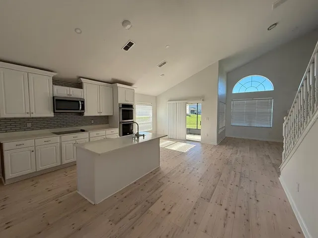 a view of kitchen with sink and cabinets