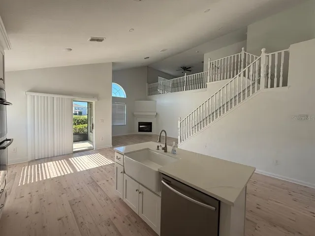 a kitchen with a sink and a wooden floor