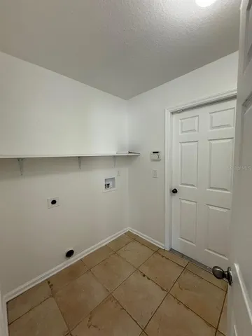 a open kitchen with cabinets stove and wooden floor