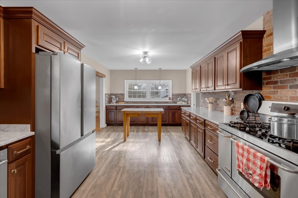 1007 Sycamore Drive Manchester, TN 37355 - Photo 13 of 100 a kitchen with stainless steel appliances a stove a refrigerator and cabinets