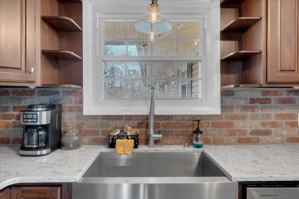 1007 Sycamore Drive Manchester, TN 37355 - Photo 14 of 100 a kitchen with a sink and a refrigerator