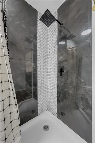 a bedroom with a bed a desk and chair