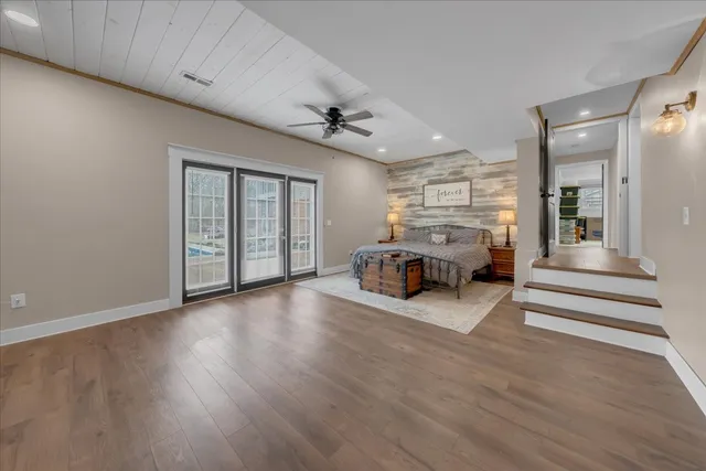 a kitchen with stainless steel appliances granite countertop a stove and a wooden floors