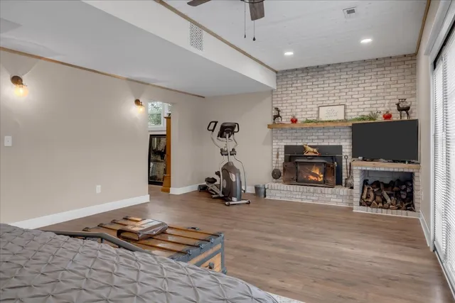 a view of a swimming pool with a patio and wooden fence