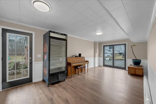 a view of a backyard with potted plants and wooden fence