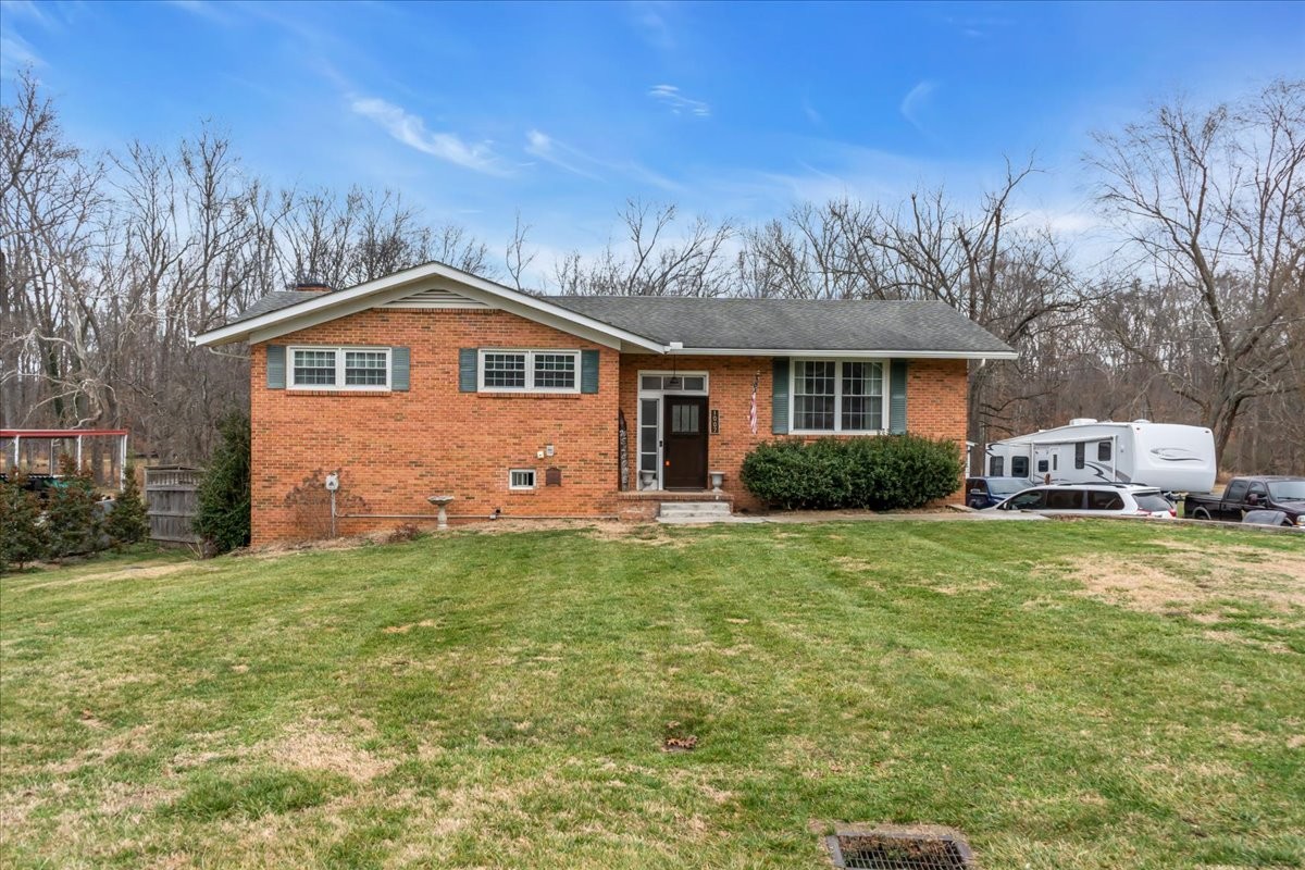 1007 Sycamore Drive Manchester, TN 37355 - Photo 52 of 100 a front view of a house with a garden and trees