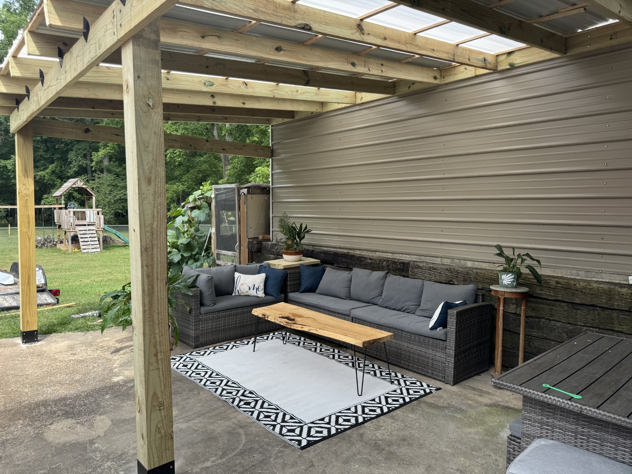 1007 Sycamore Drive Manchester, TN 37355 - Photo 91 of 100 a view of a patio with couches and a dining table and chairs with outer view