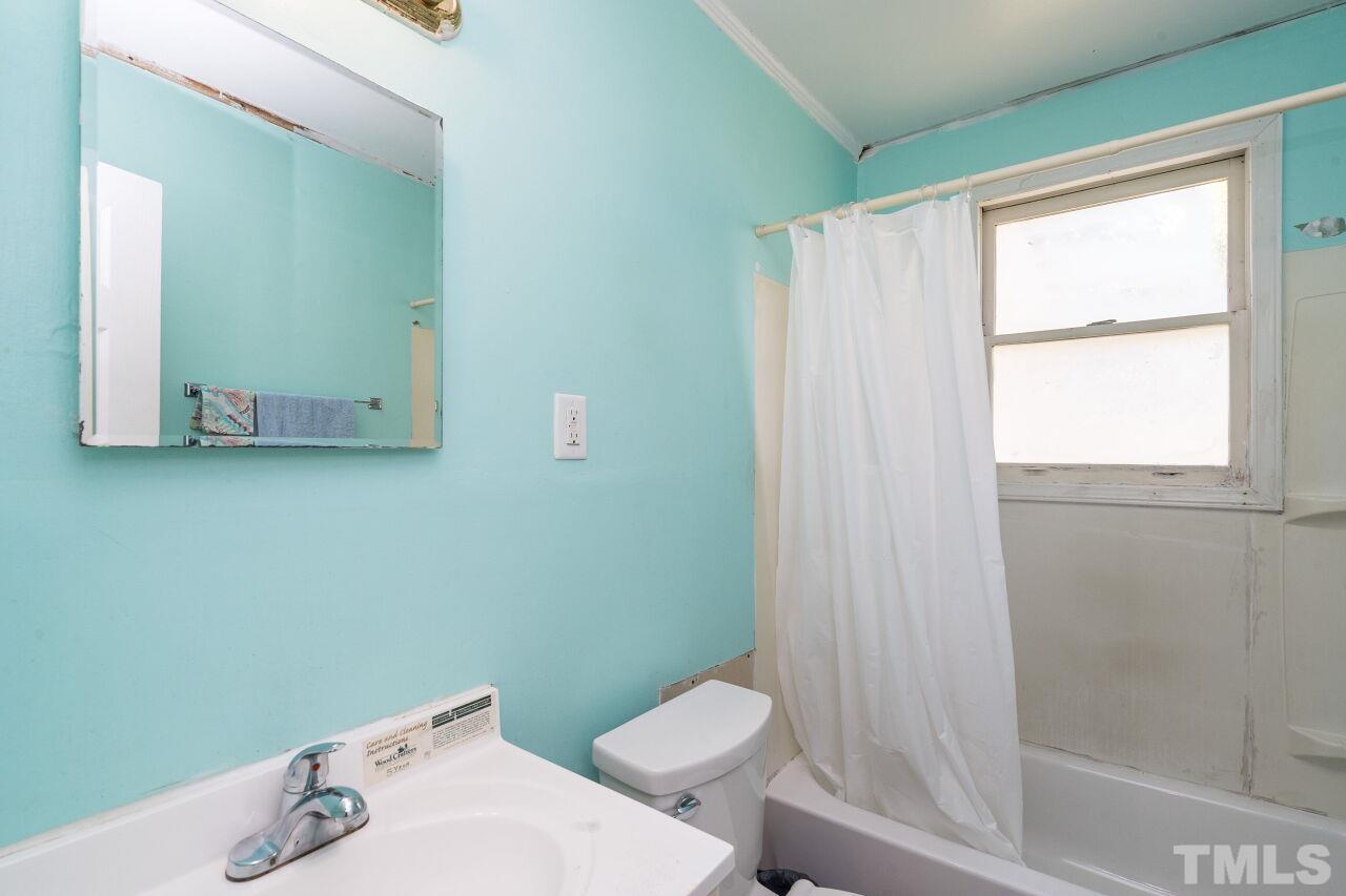 813 North King Charles Road Raleigh, NC 27610 - Photo 12 of 20 a white toilet sitting next to a bathroom sink