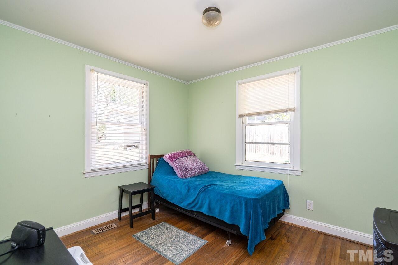813 North King Charles Road Raleigh, NC 27610 - Photo 13 of 20 a bedroom with a bed and a window