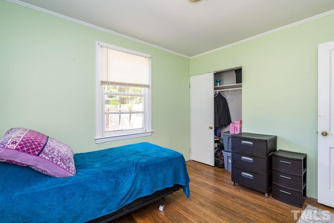 813 North King Charles Road Raleigh, NC 27610 - Photo 14 of 20 a bedroom with a bed and wooden floor