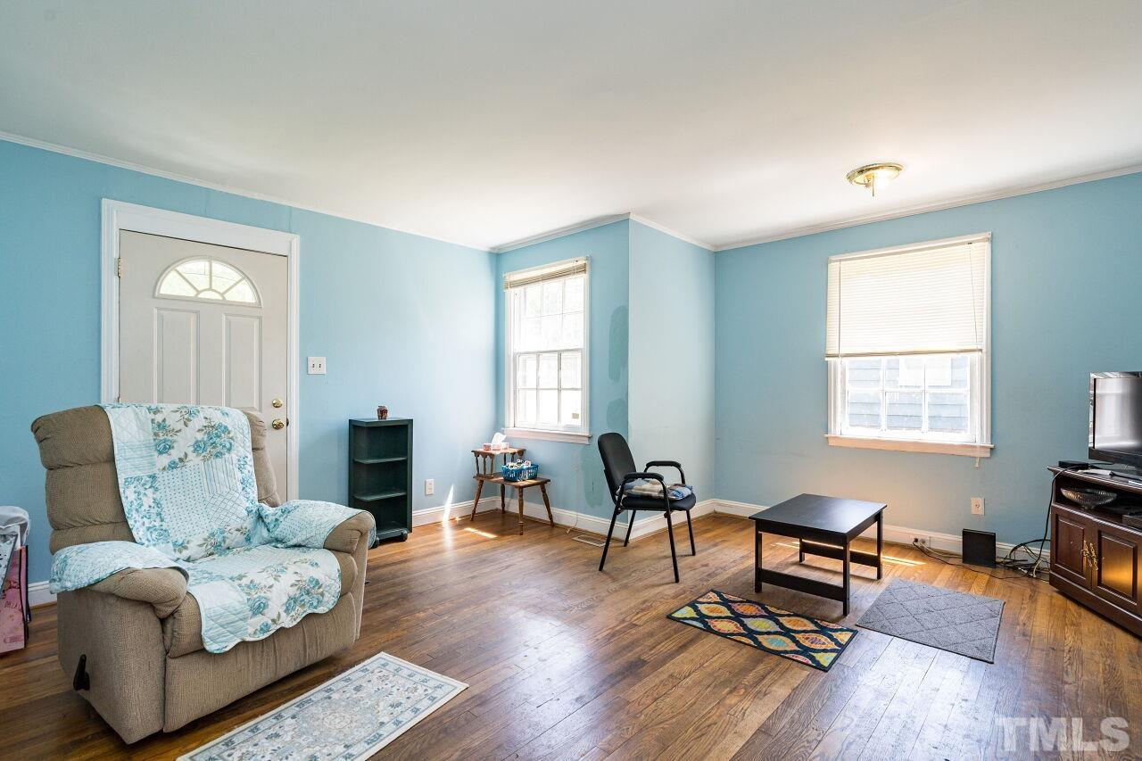 813 North King Charles Road Raleigh, NC 27610 - Photo 4 of 20 a living room with furniture and a window