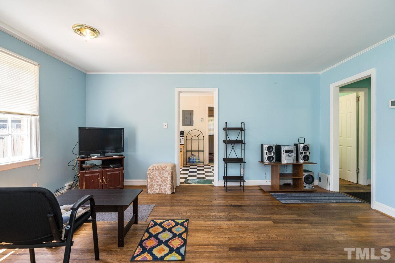 813 North King Charles Road Raleigh, NC 27610 - Photo 6 of 20 a living room with furniture and a flat screen tv