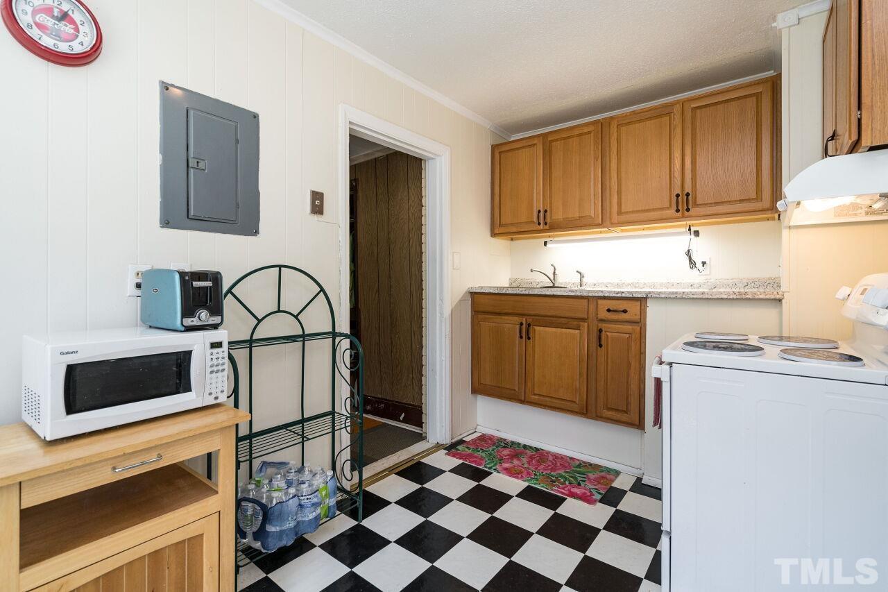 813 North King Charles Road Raleigh, NC 27610 - Photo 7 of 20 a kitchen with a stove a sink and a refrigerator