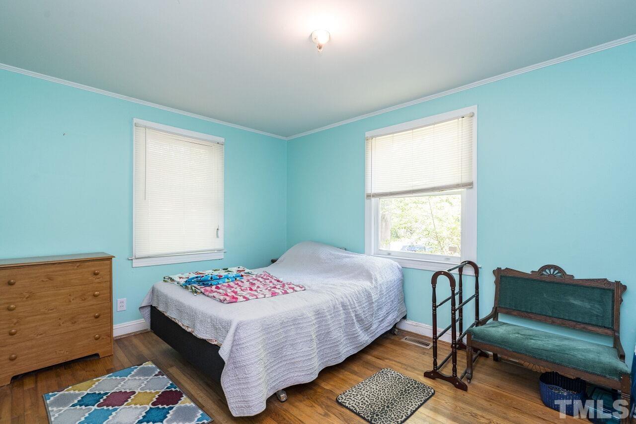 813 North King Charles Road Raleigh, NC 27610 - Photo 10 of 20 a bedroom with a bed and a couch