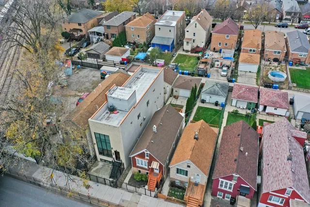 an aerial view of residential houses with outdoor space