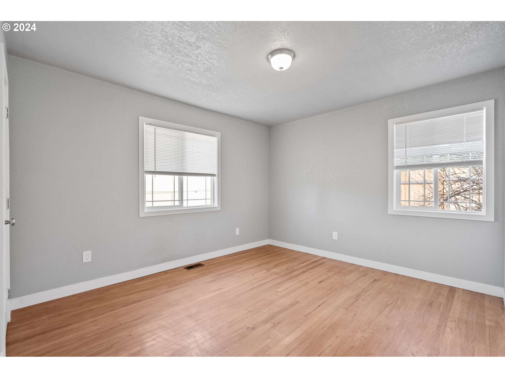 805 Southwest 28th Street Pendleton, OR 97801 - Photo 17 of 25 an empty room with wooden floor and windows
