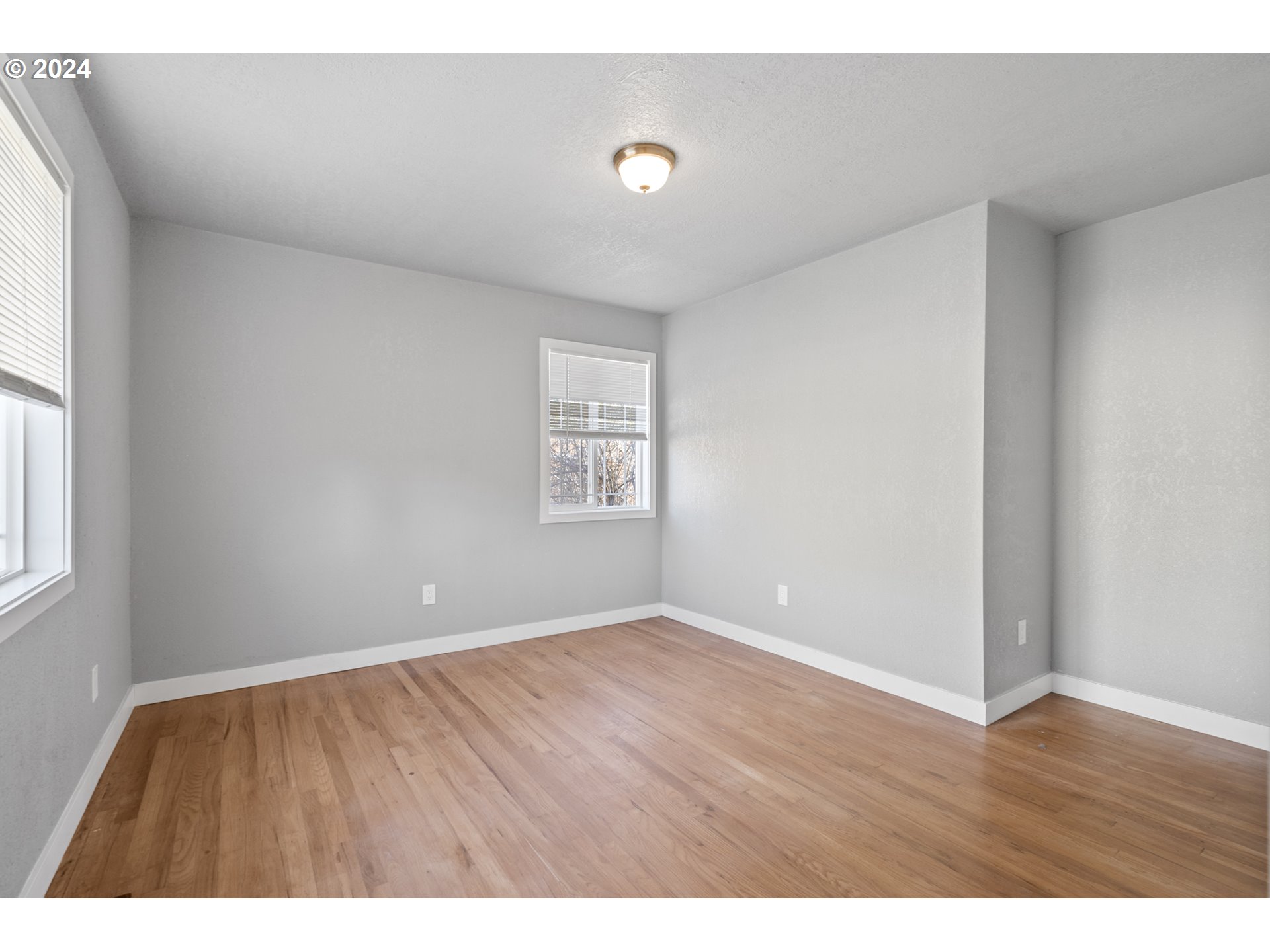 805 Southwest 28th Street Pendleton, OR 97801 - Photo 18 of 25 a view of an empty room with wooden floor and a window