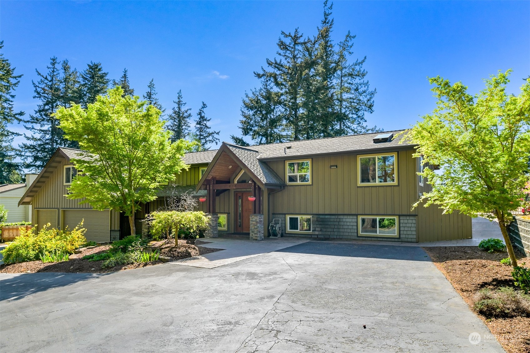 a view of a house with a yard and potted plants