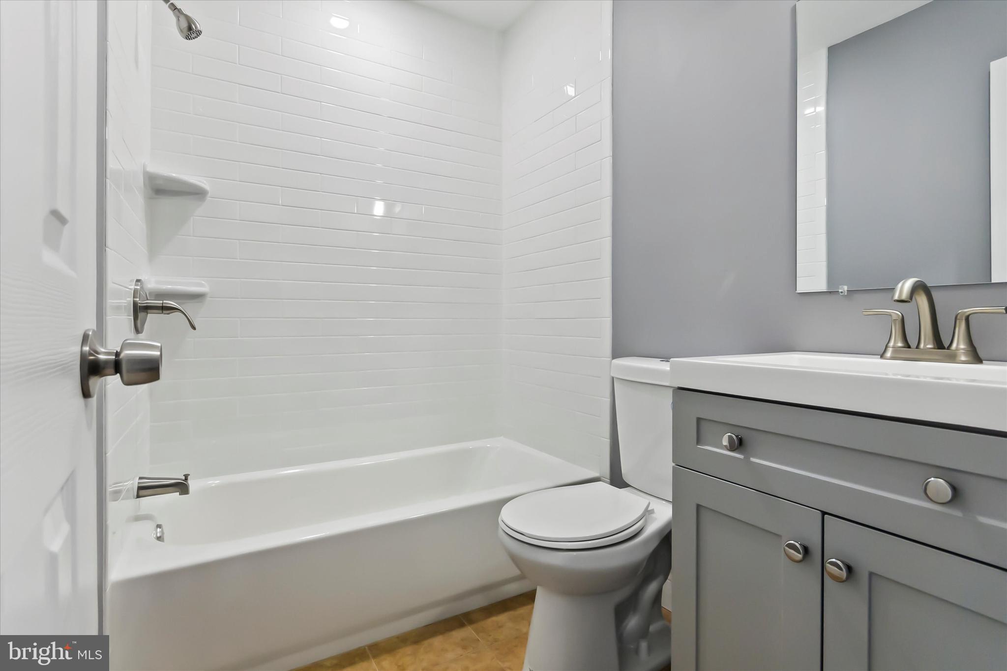 296 Greenough Street, Unit 2 Philadelphia, PA 19127 - Photo 19 of 24 a bathroom with a sink a toilet and shower