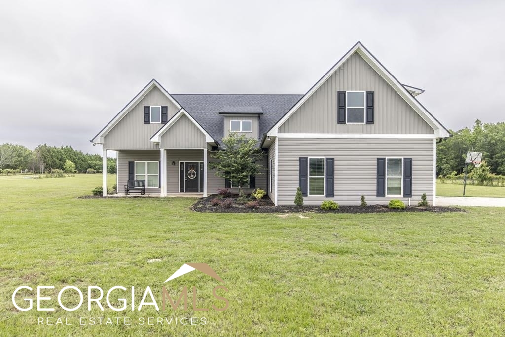 280 Terrell Road Elko, GA 31025 - Photo 1 of 1 a front view of a house with a garden and porch