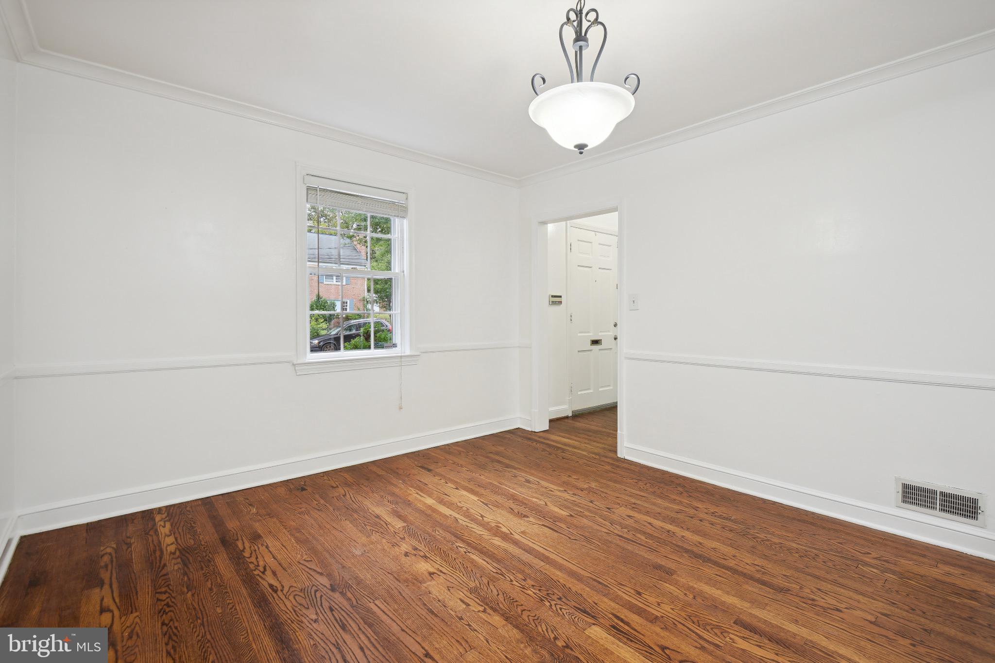 2926 Kanawha Street Northwest Washington, DC 20015 - Photo 11 of 34 an empty room with wooden floor and windows