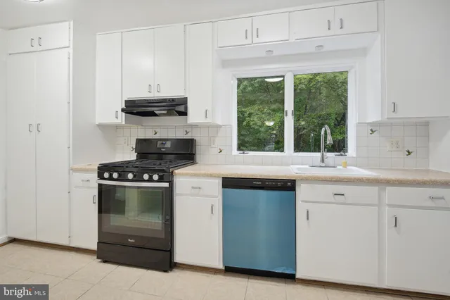 a kitchen with granite countertop a stove and a sink