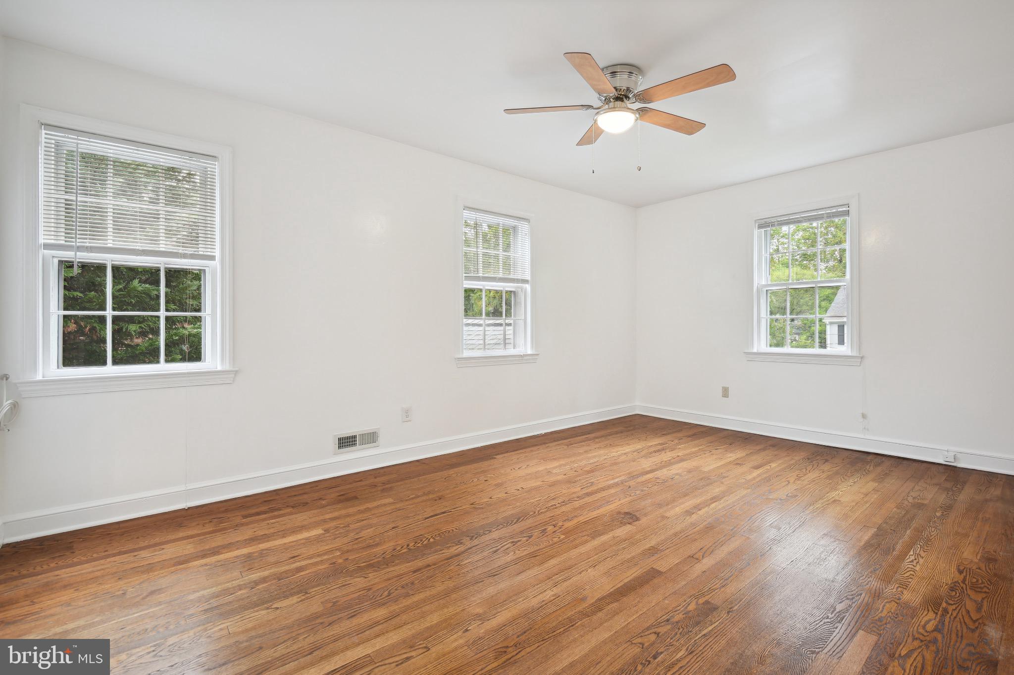 2926 Kanawha Street Northwest Washington, DC 20015 - Photo 18 of 34 a view of an empty room with wooden floor and a window