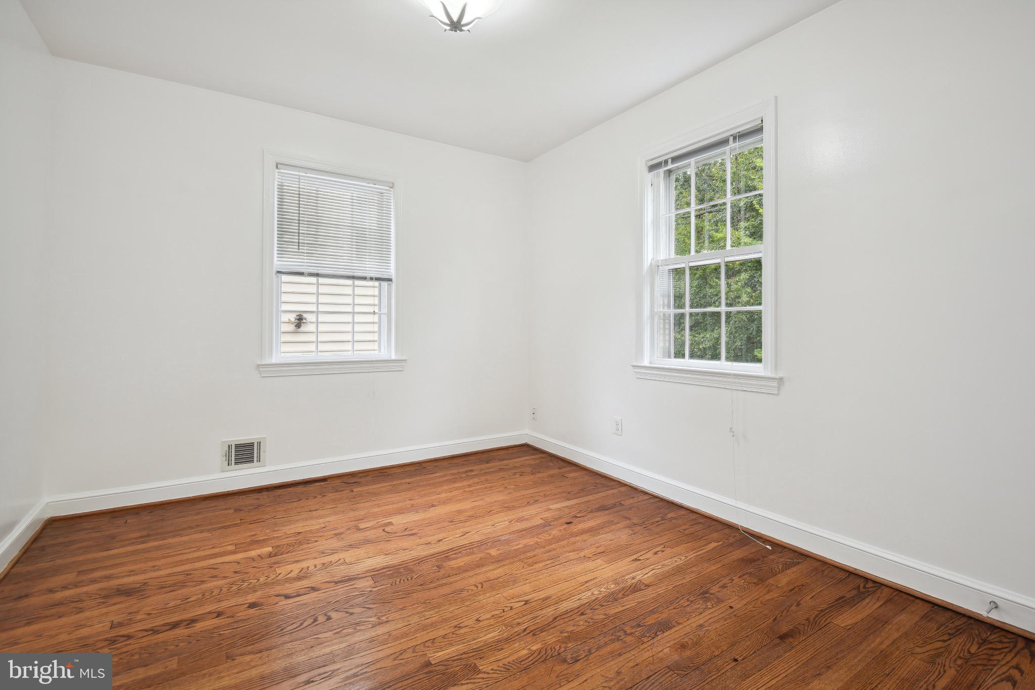 2926 Kanawha Street Northwest Washington, DC 20015 - Photo 20 of 34 an empty room with wooden floor and windows
