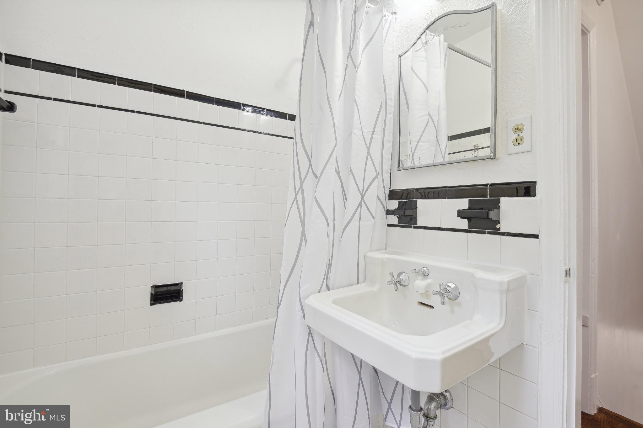 2926 Kanawha Street Northwest Washington, DC 20015 - Photo 22 of 34 a bathroom with a sink and a mirror