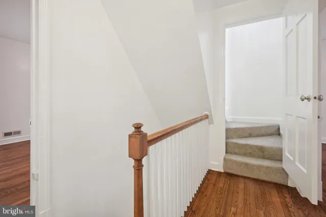 a view of a hallway with wooden floor and entryway